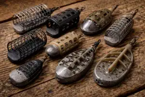 Selection of swim feeders on a rustic wooden background